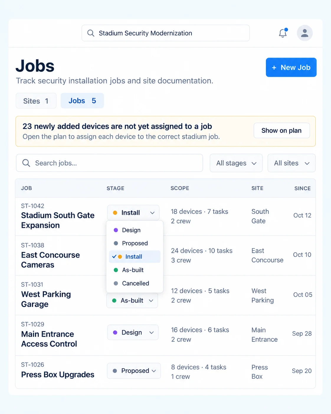 eyeOT Jobs view for a stadium security modernization: five installation jobs tracked by stage from Design to As-built, each with device, task and crew counts, and a prompt that 23 newly added devices are not yet assigned to a job